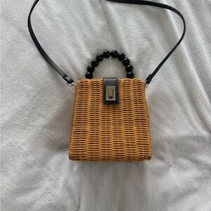 Elegant Tan Woven Handbag with Black Accents
